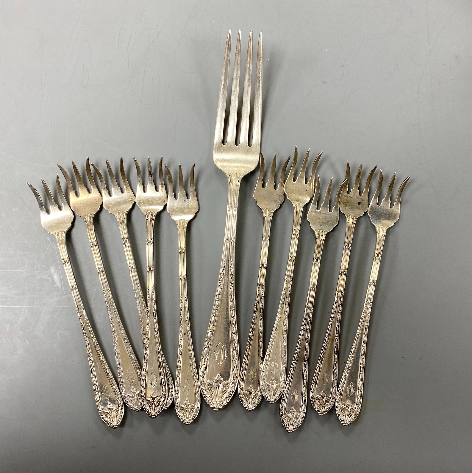 A set of ten Cartier sterling tea forks, 13.4cm and a similar table fork, 9oz.